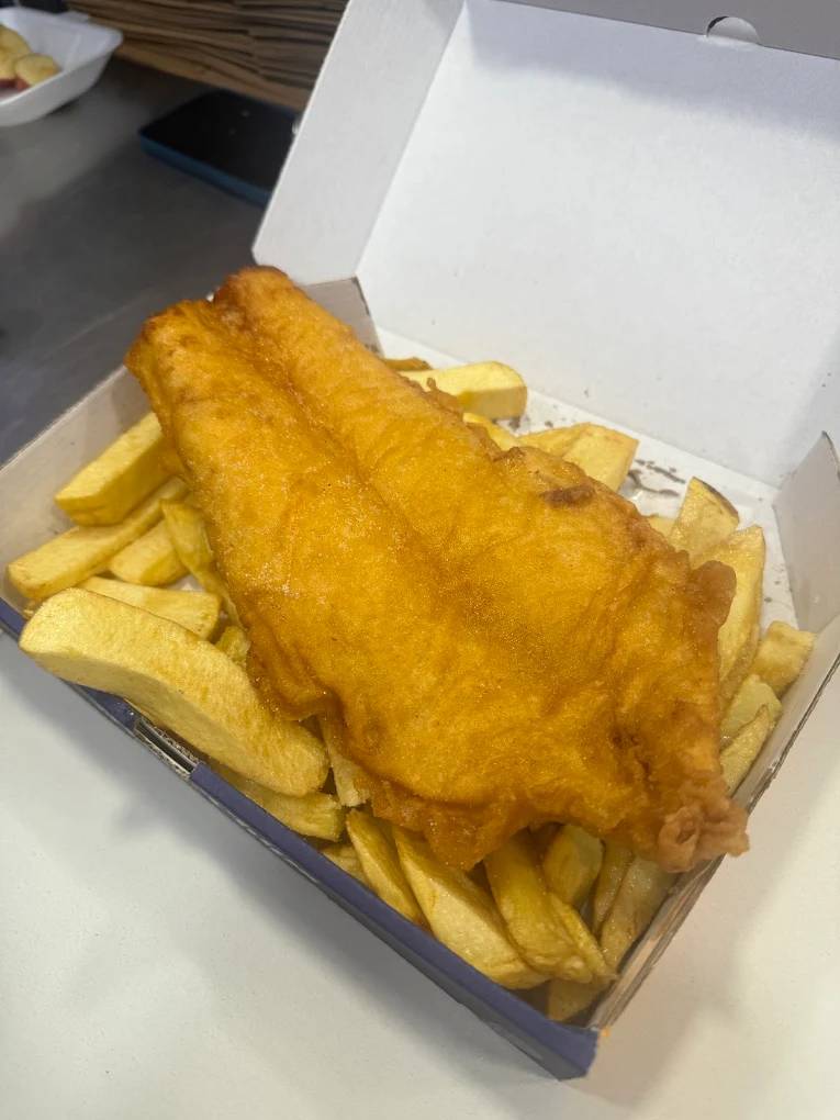 Polbeth large piece of battered fish served over a bed of thick-cut chips in Livingston.