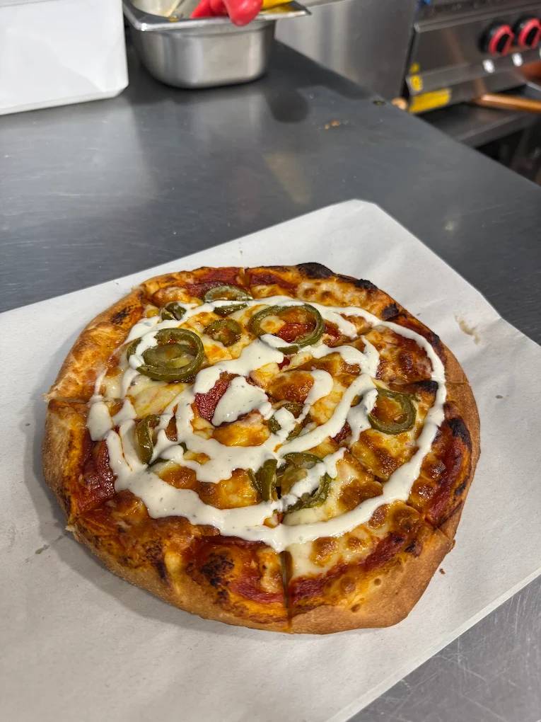 Polbeth small pizza topped with jalapenos and a swirl of white sauce in Livingston.